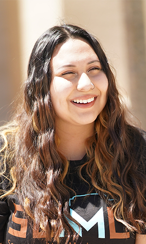 Student Smiling sitting on a bench 