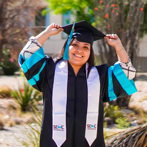 Graduate with regalia outside